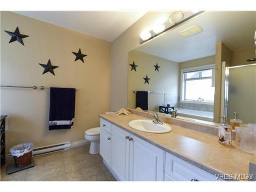 The laundry room offers storage and access to the garage