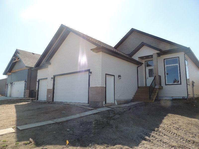 BRAND NEW HOME C/w triple car garage in the Village of Kitscoty