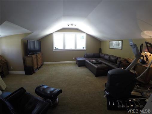 The kitchen leads out to the covered deck and lower patio