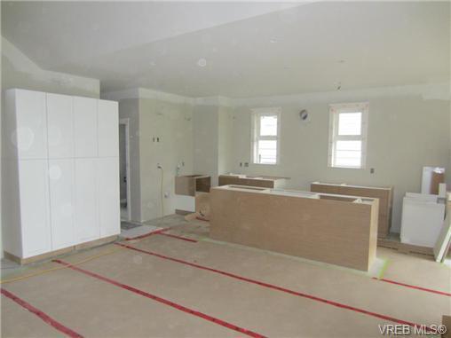 The spacious kitchen boasts gorgeous solid surface countertops