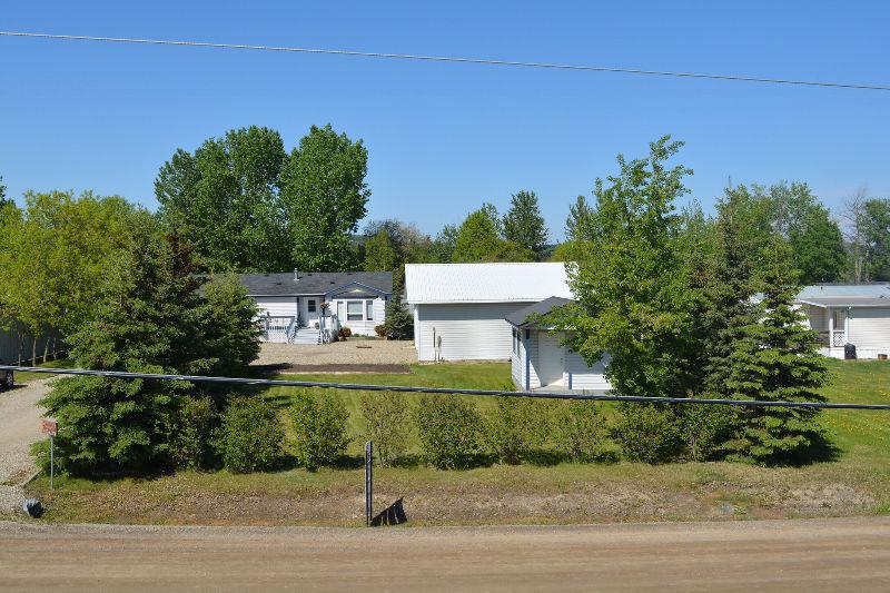 Modular home with shop, cabin and storage sheds on 1/2 acre lot